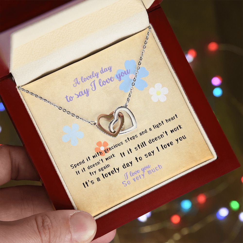 I love you message card with Interlocking Hearts (polished stainless steal and rose gold finish), hand holding it in Mahogany style luxury box - Sheer: your Luck - Sheerluck-art.com
